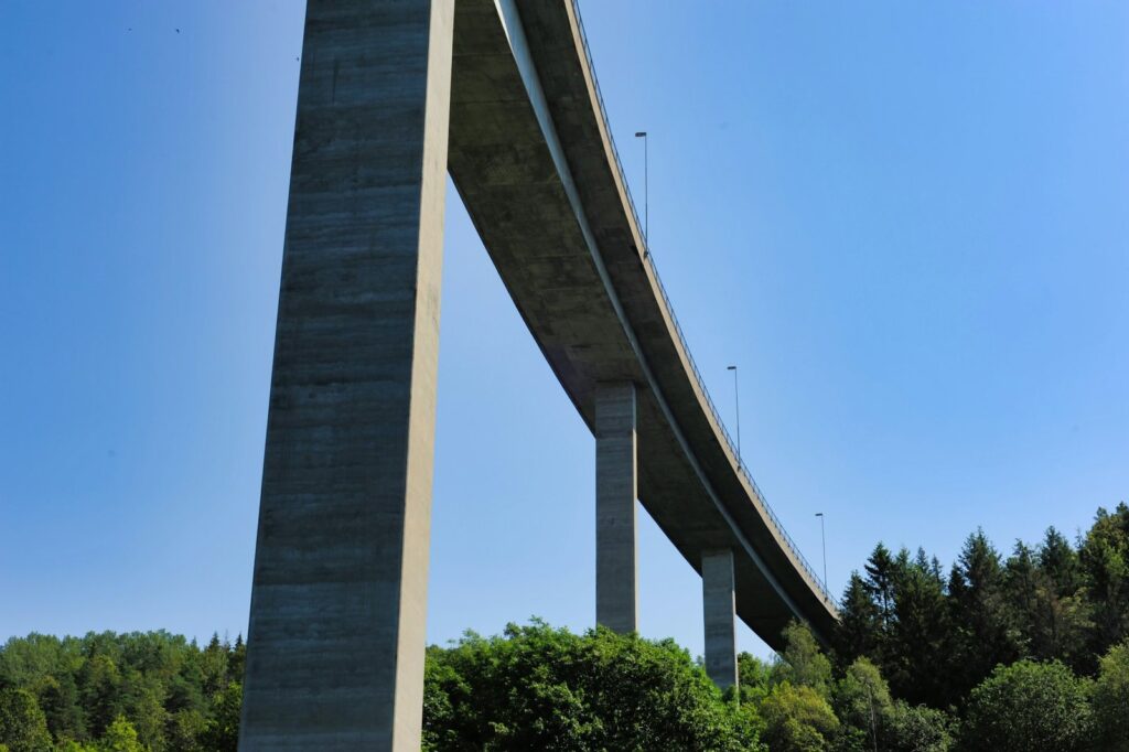 Curved concrete road viaduct on tall slender piers