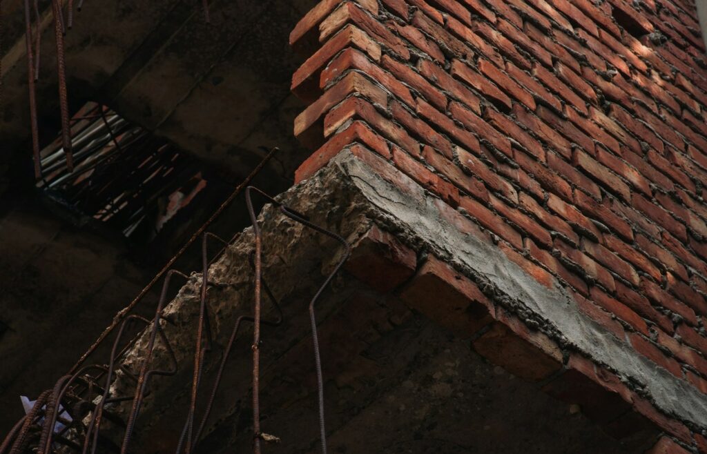 Broken concrete slab edge with exposed, rusted reinforcing bars